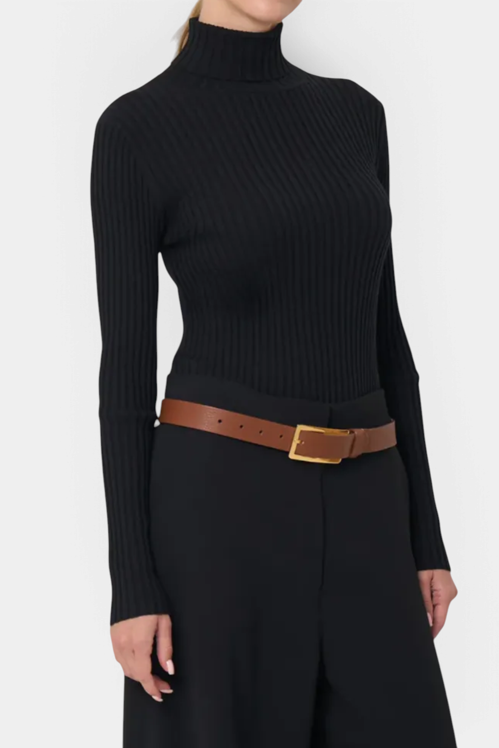 The Copper Shed Ivy black ribbed turtleneck sweater with long sleeves worn with a brown leather belt
