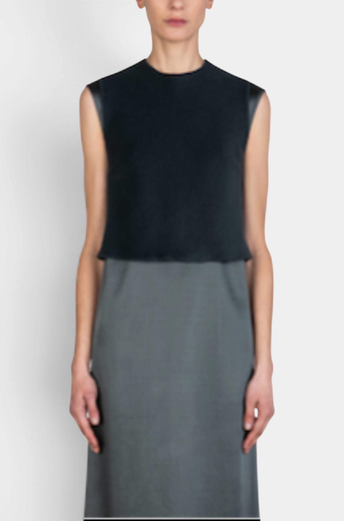 The Copper Shed black sleeveless satin shift dress with a layered bodice design worn by a model.