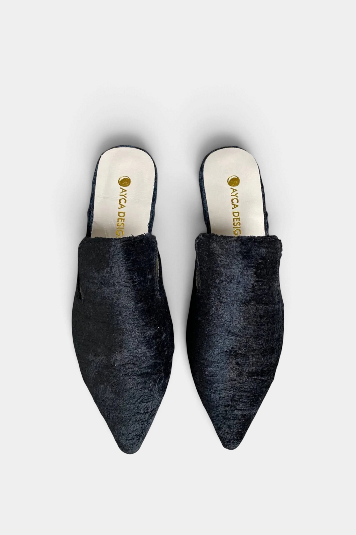 The Copper Shed black silk velvet ikat pointed-toe slides with an open-back design and genuine leather lining.