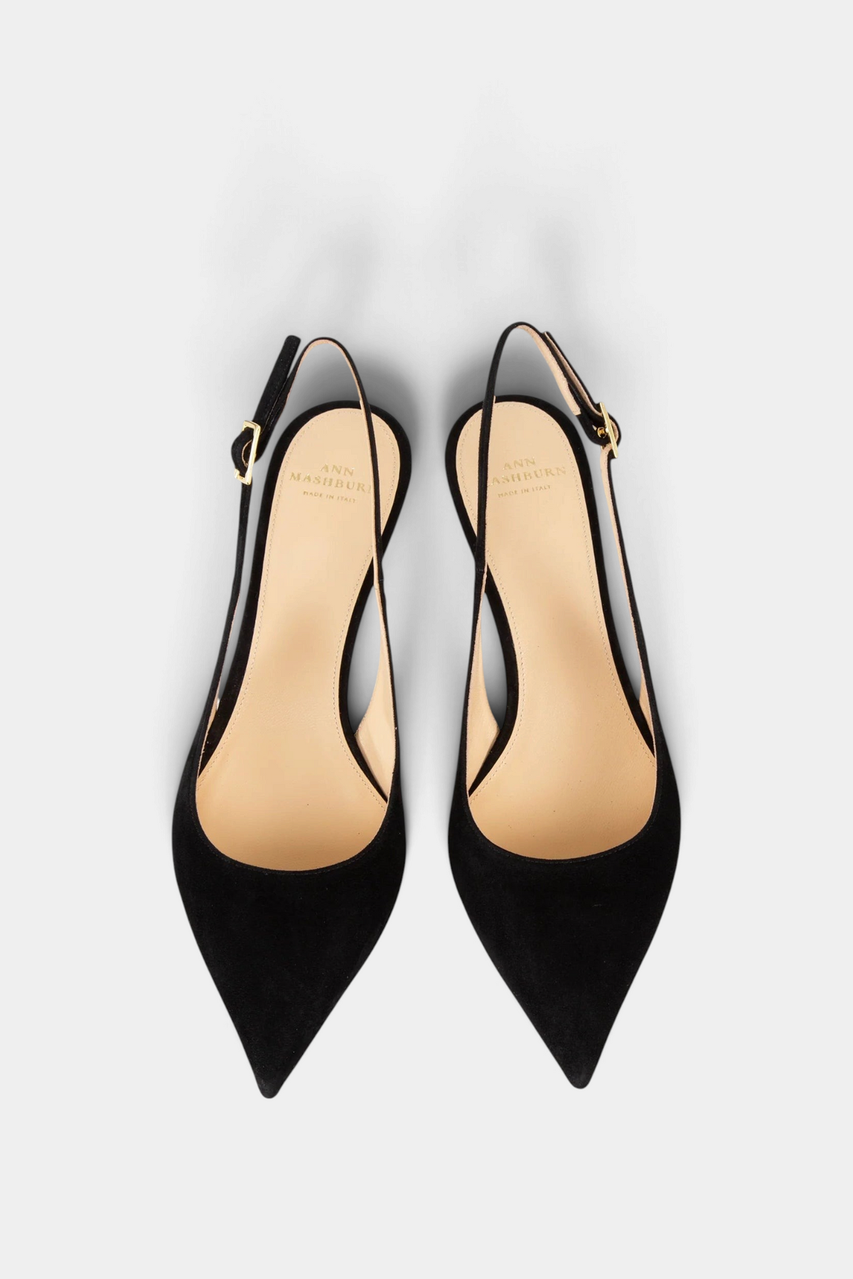 The Copper Shed black Italian kid suede kitten heel slingback shoes with a pointed toe and buckle strap.