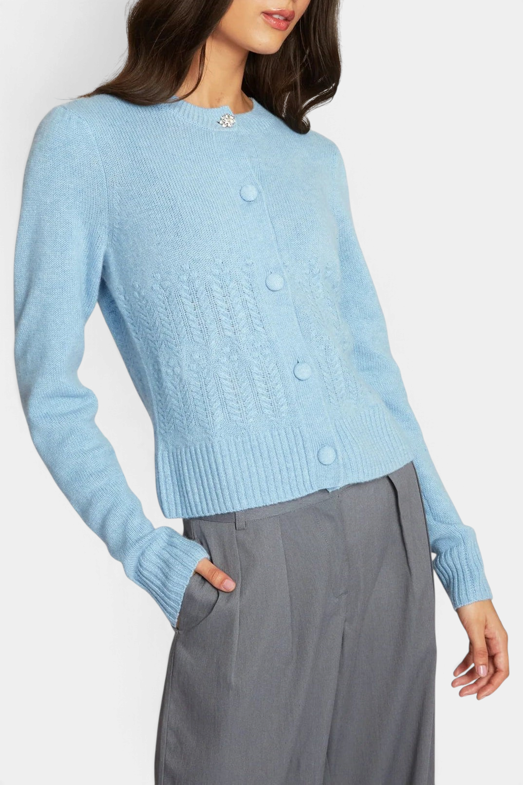 The Copper Shed heather blue cashmere cardigan with puff sleeves, popcorn stitch, and a crystal button at the neck.