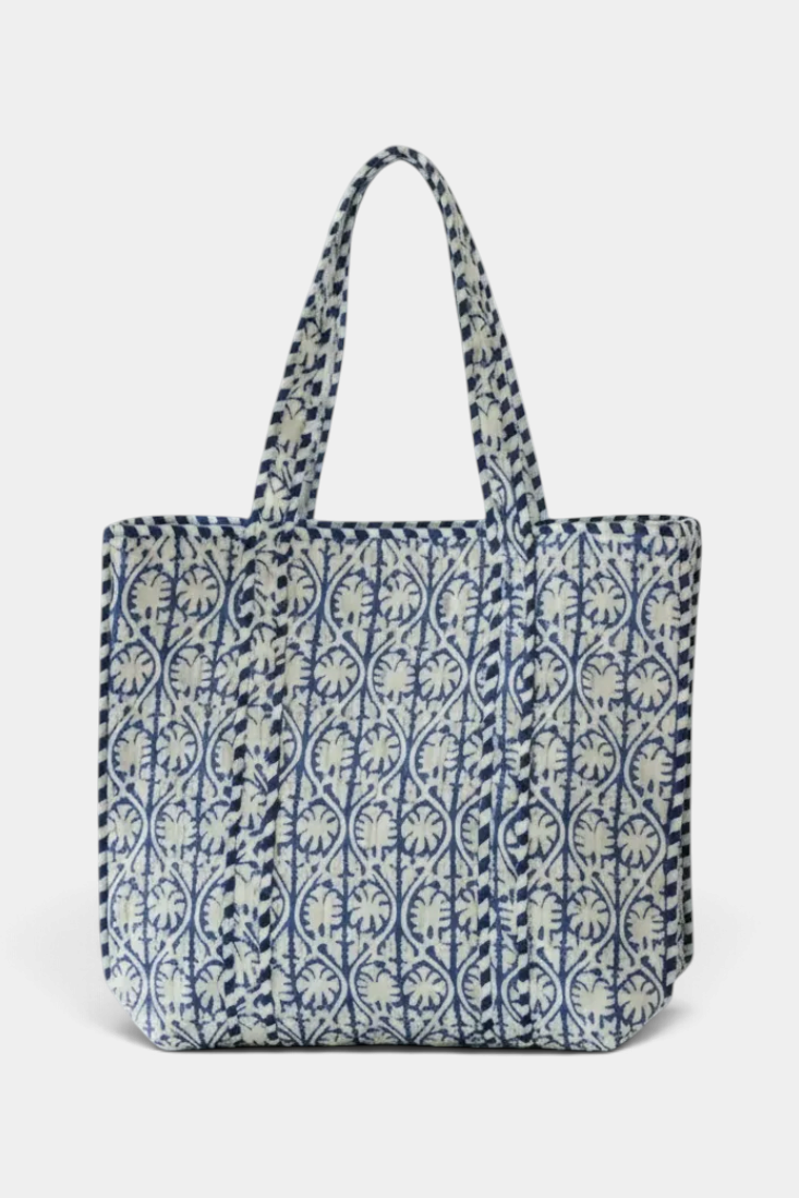The Copper Shed reversible quilted cotton tote bag featuring a blue and white hand-printed floral block pattern.