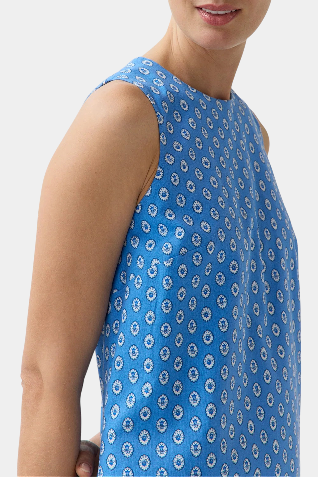 The Copper Shed Susy shift dress in blue cotton poplin with a white floral print and sleeveless A-line silhouette.