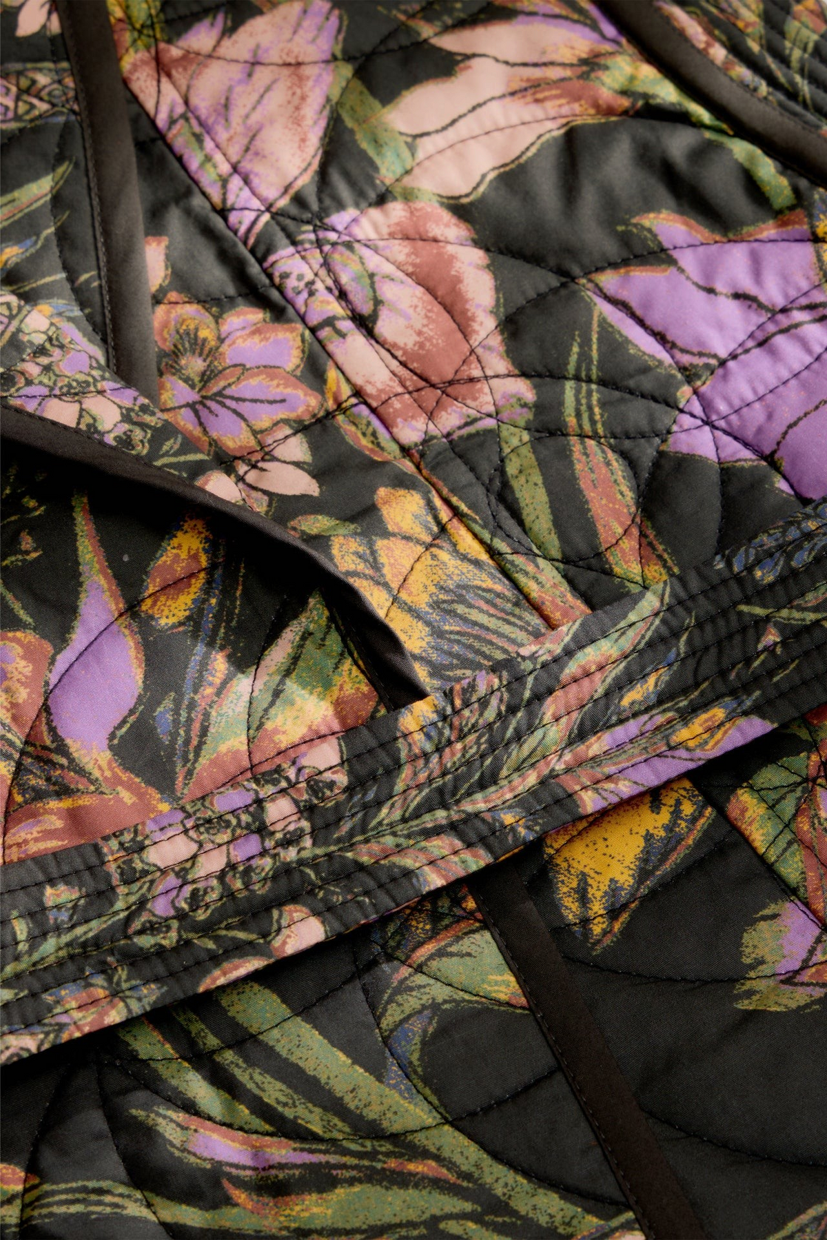 The Copper Shed Bowie vest featuring a moody floral print on quilted cotton fabric with a shawl collar and tie belt.