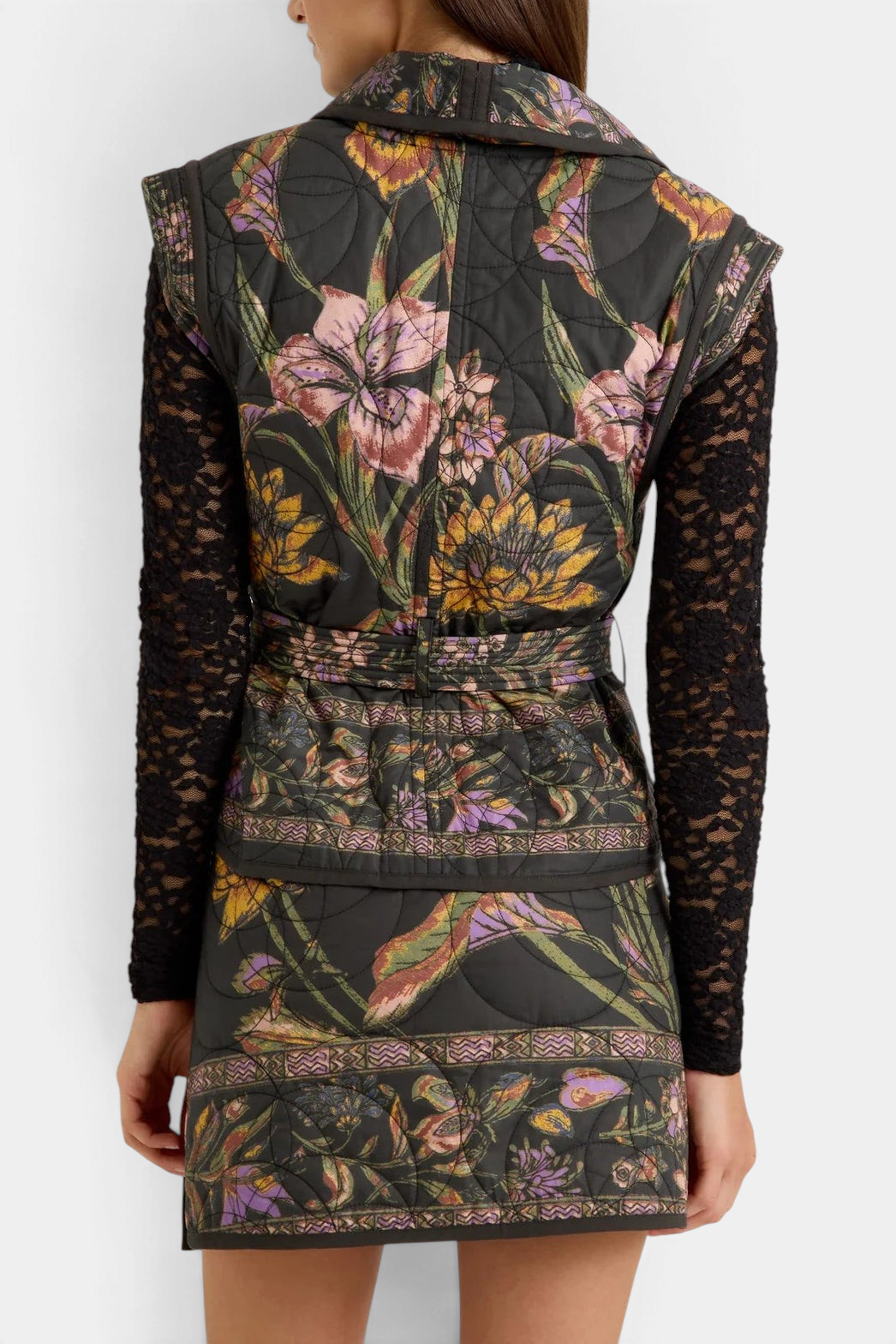 The Copper Shed Bowie vest in black floral quilted cotton with a shawl collar and tie belt, back view.