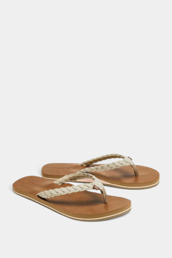The Copper Shed Braided Pacifica flip flops featuring a tan synthetic leather sole and a beige braided strap.