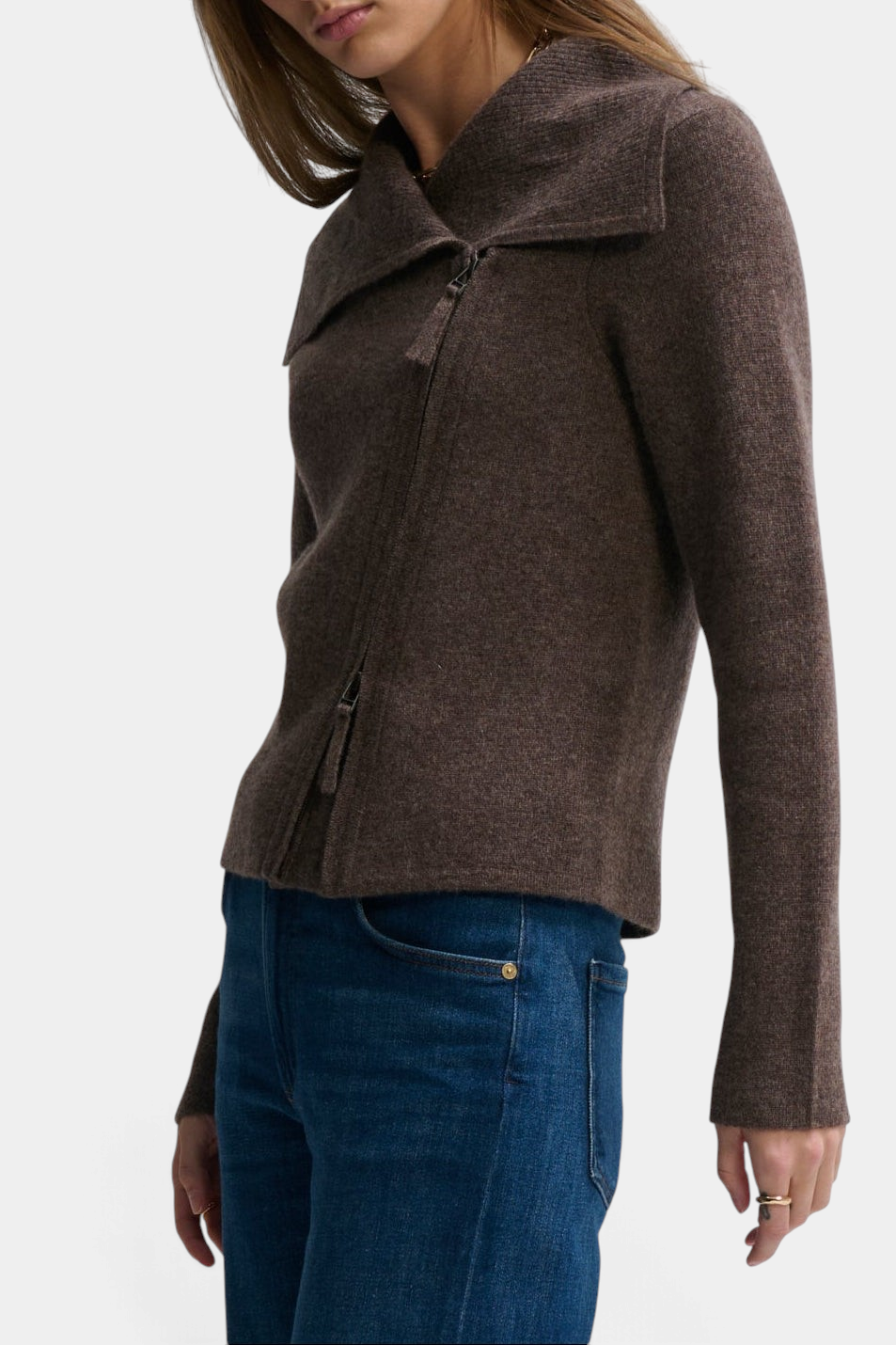 The Copper Shed St Bridget brown cashmere moto zip-up sweater with an asymmetric collar worn with blue jeans.