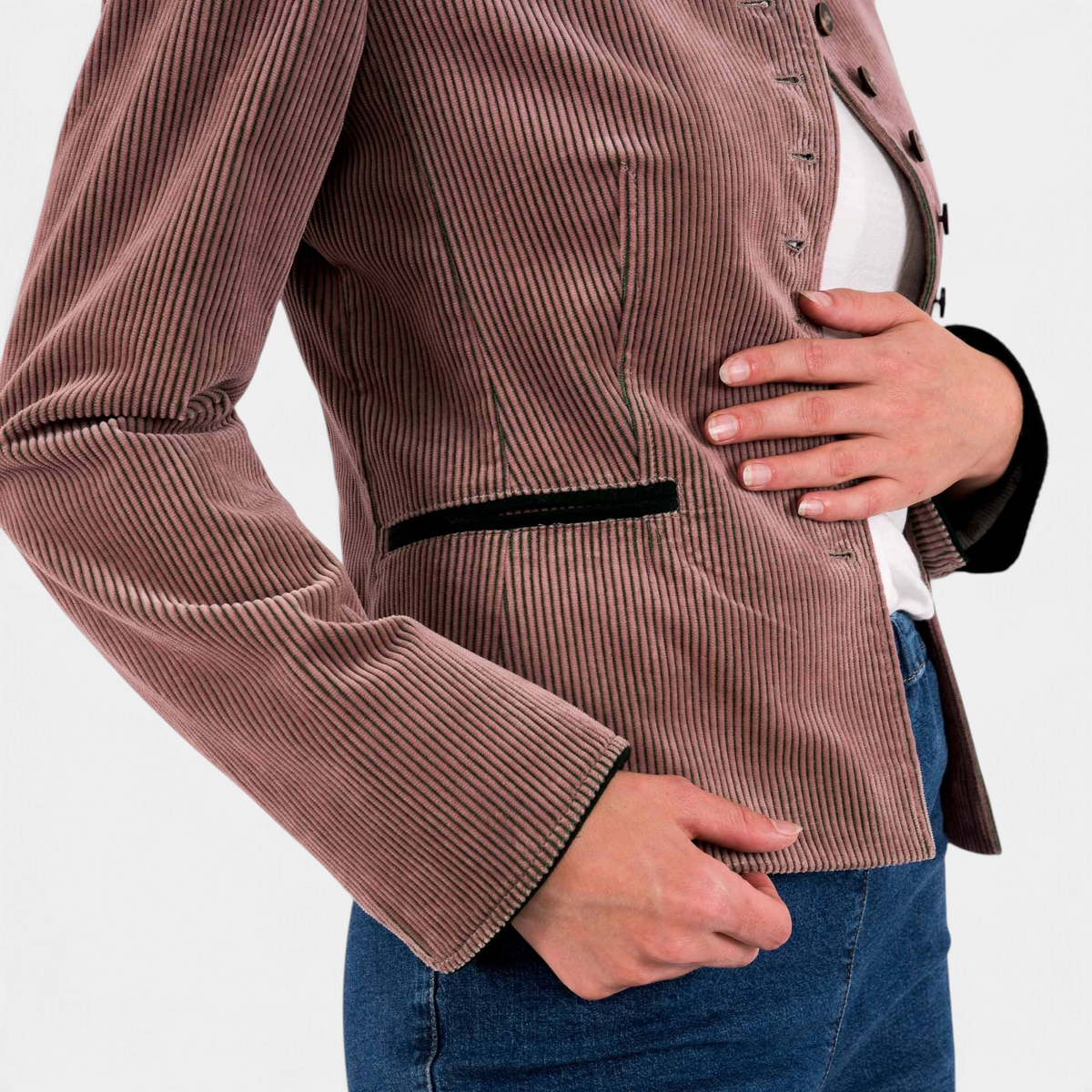 The Copper Shed women's brown corduroy Alpine blazer with black trim details worn over a white shirt and blue jeans.