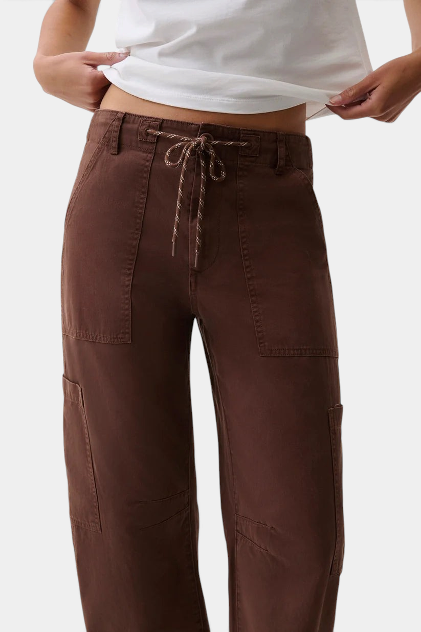 The Copper Shed Sabrina curved utility pants in brown cotton twill with a drawstring waistband and cargo pockets.