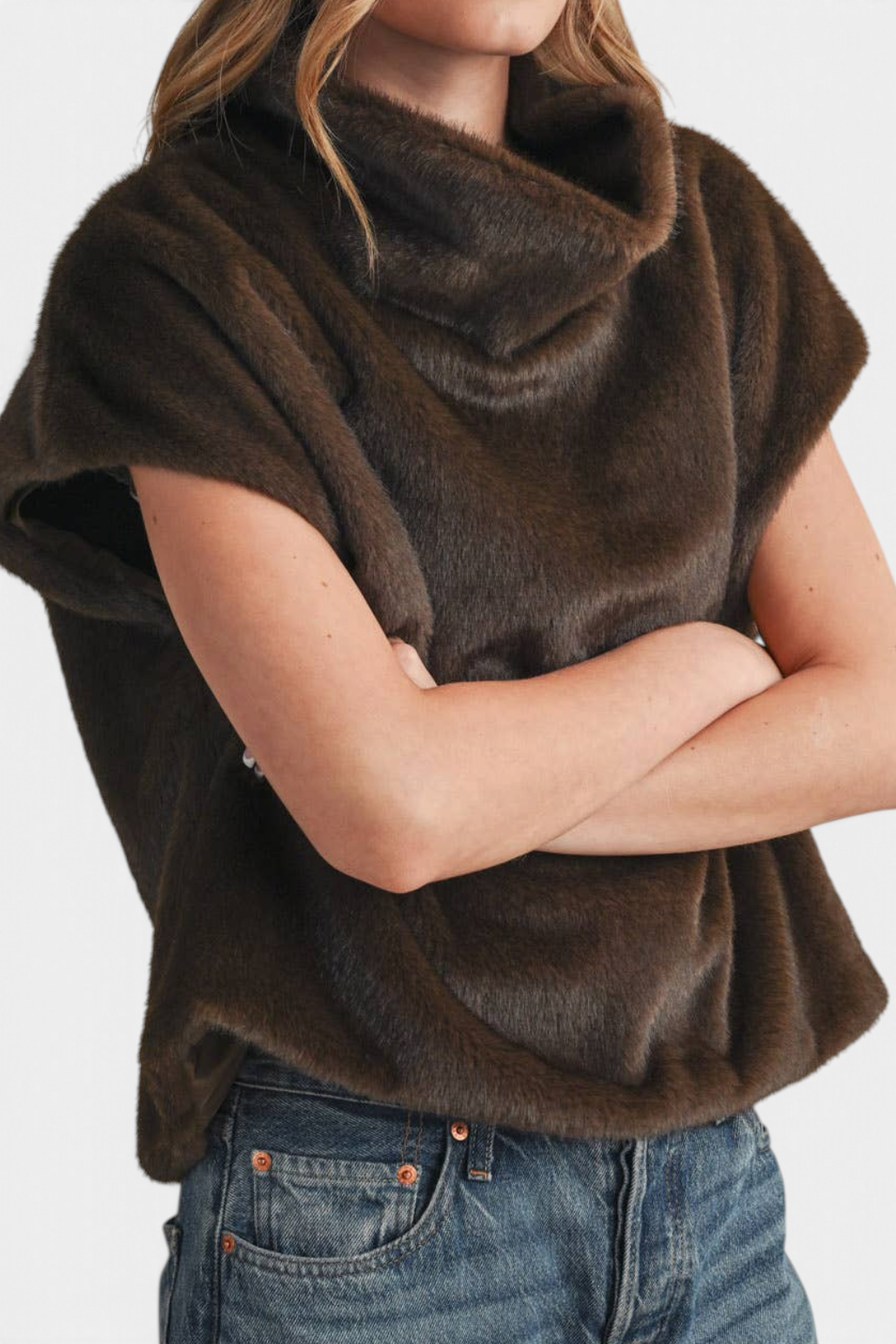 The Copper Shed brown faux fur turtleneck top with cap sleeves and a relaxed fit worn with blue jeans