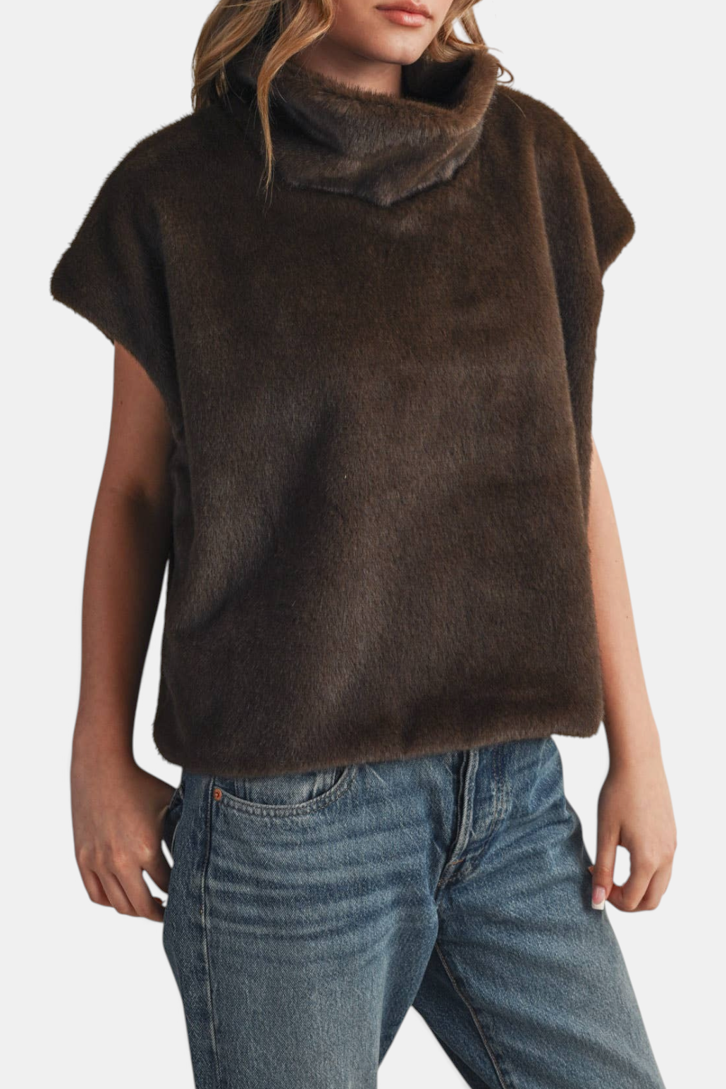 The Copper Shed brown faux fur turtleneck top with cap sleeves and a relaxed fit worn with blue jeans