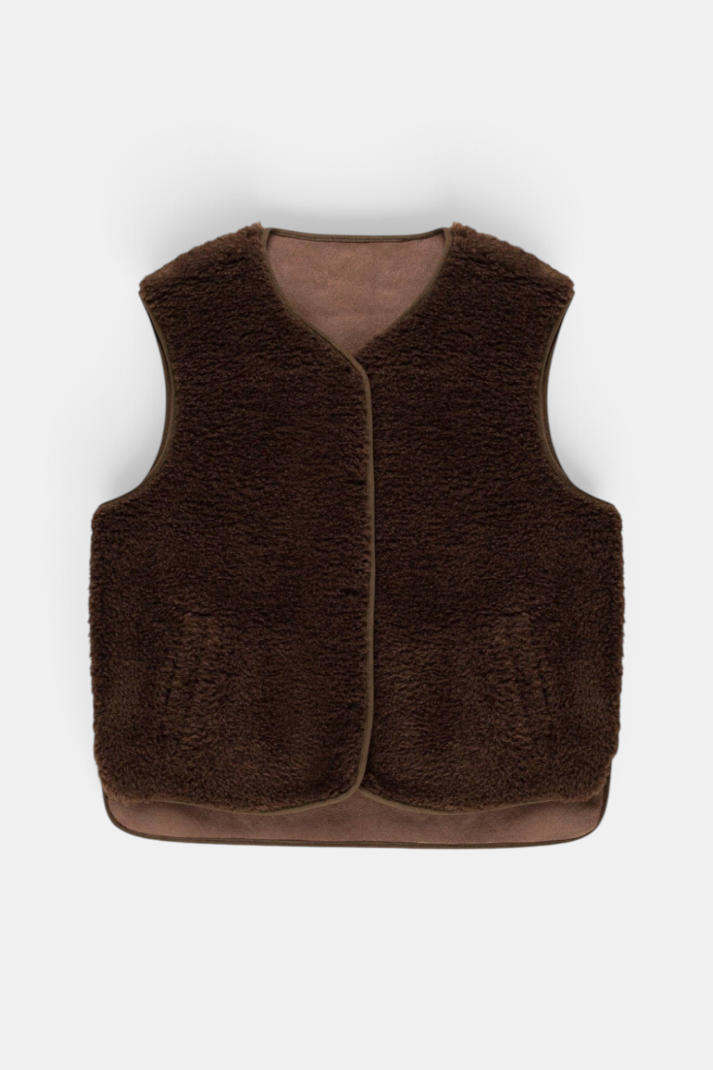 The Copper Shed dark brown faux suede and sheepskin gilet with a cropped fit, popper fastening, and front pockets.