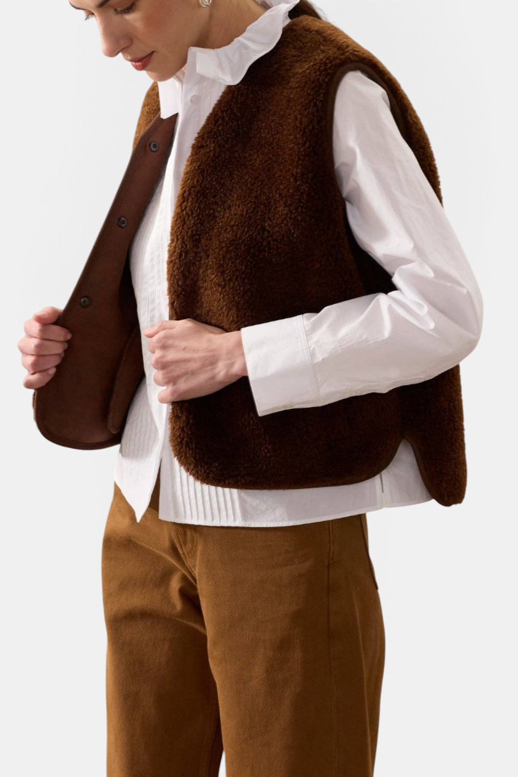 The Copper Shed brown faux suede and sheepskin cropped gilet with popper fastening worn over a white shirt