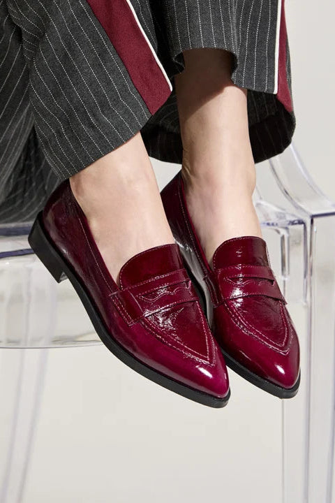 The Copper Shed Adrian pointy patent leather loafers in deep burgundy with a low rubber heel.