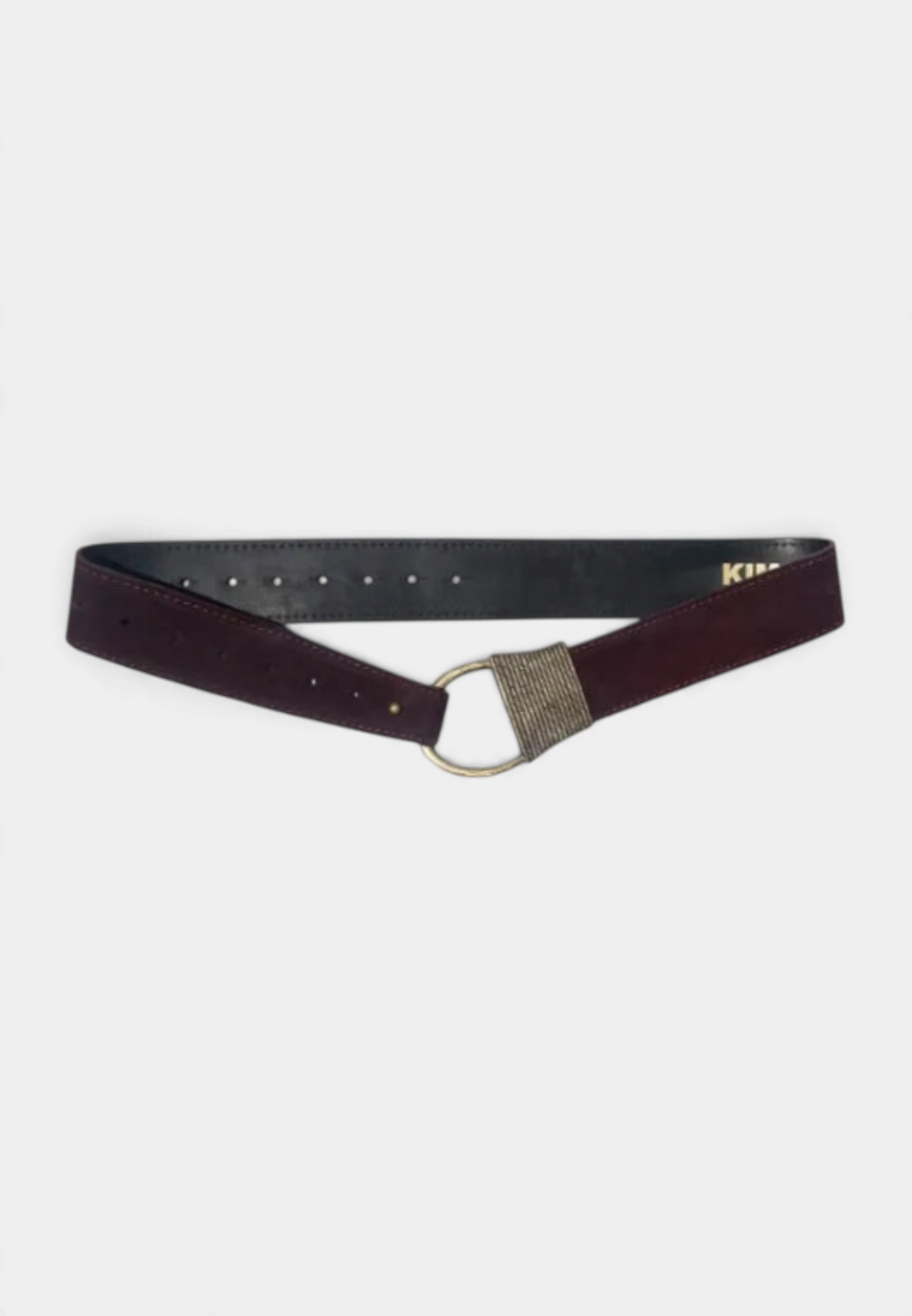 The Copper Shed Cast Rope Belt in dark burgundy suede with a metallic ring buckle and adjustable hole detailing.