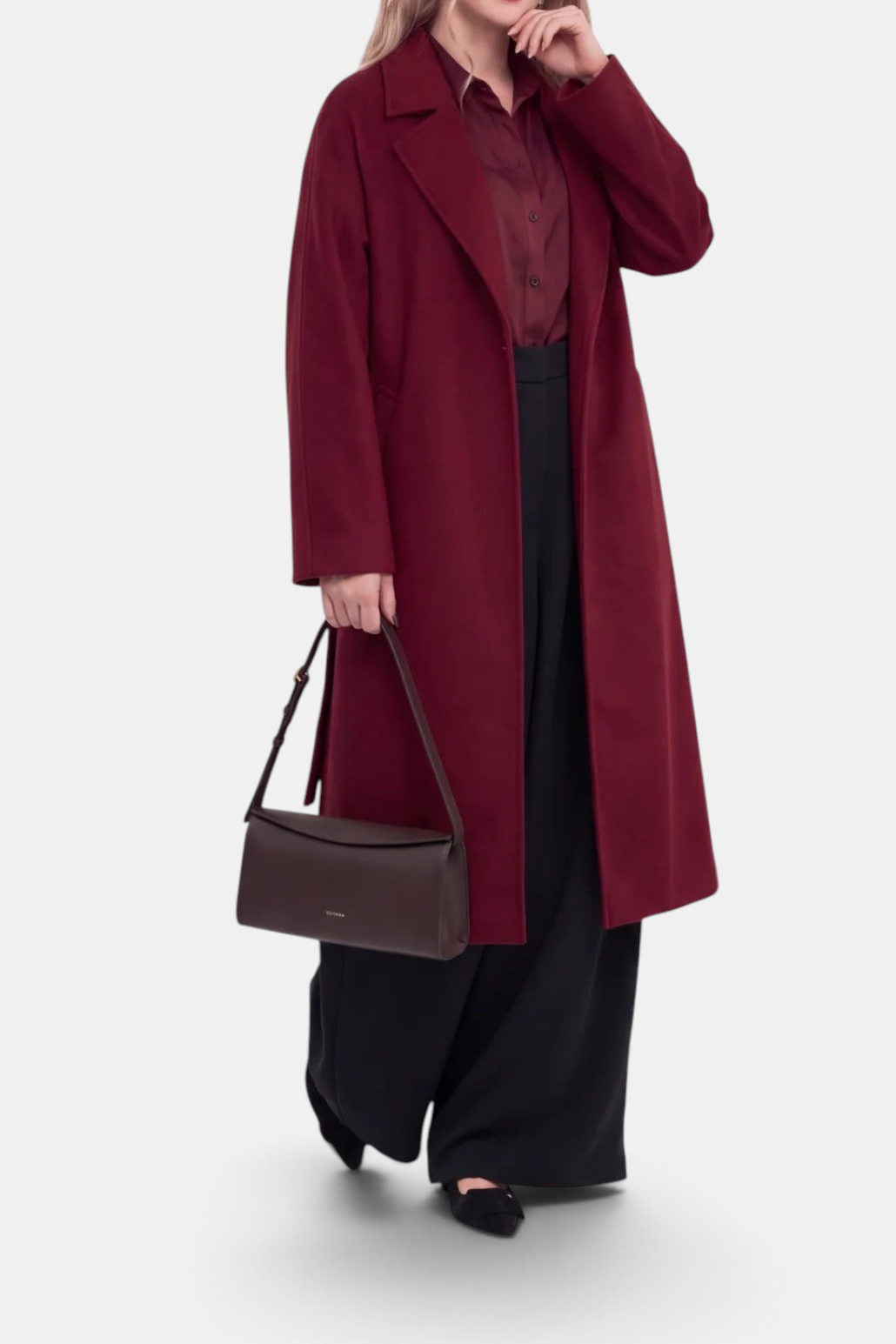 The Copper Shed burgundy wool cashmere wrap coat with notch lapels, worn by a model with black trousers and handbag.