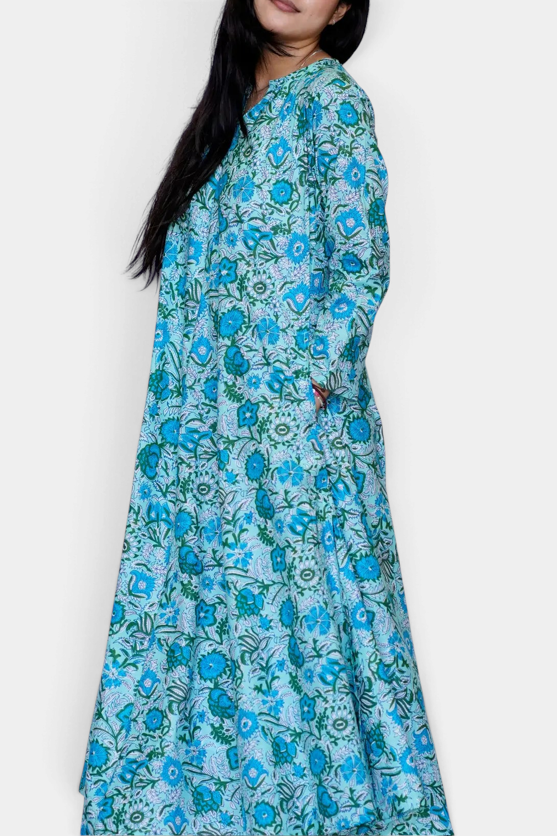 The Copper Shed Calypso dress in turquoise and sage floral cotton with an a-line silhouette and side pockets.