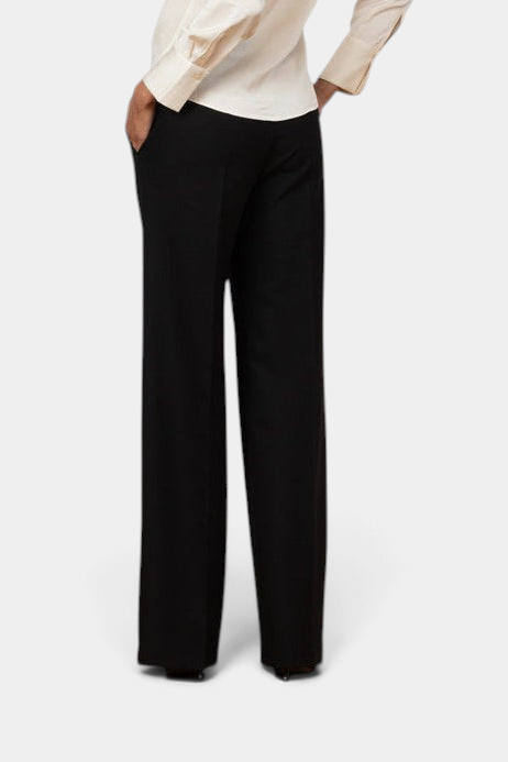 The Copper Shed Carla black palazzo pants featuring a wide-leg silhouette and side pockets, shown from the back.