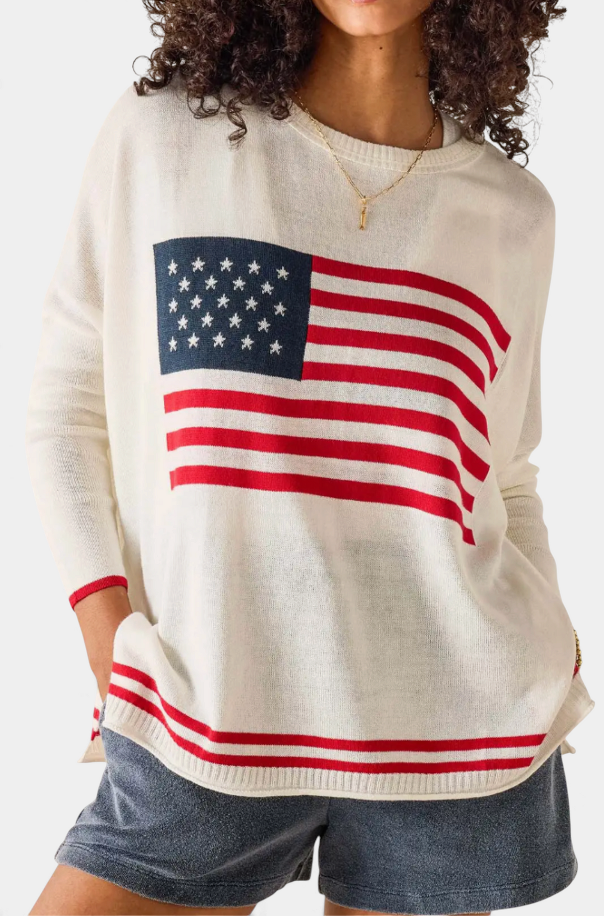 The Copper Shed Catalina flag sweater in white with a red and blue American flag knit design on the front