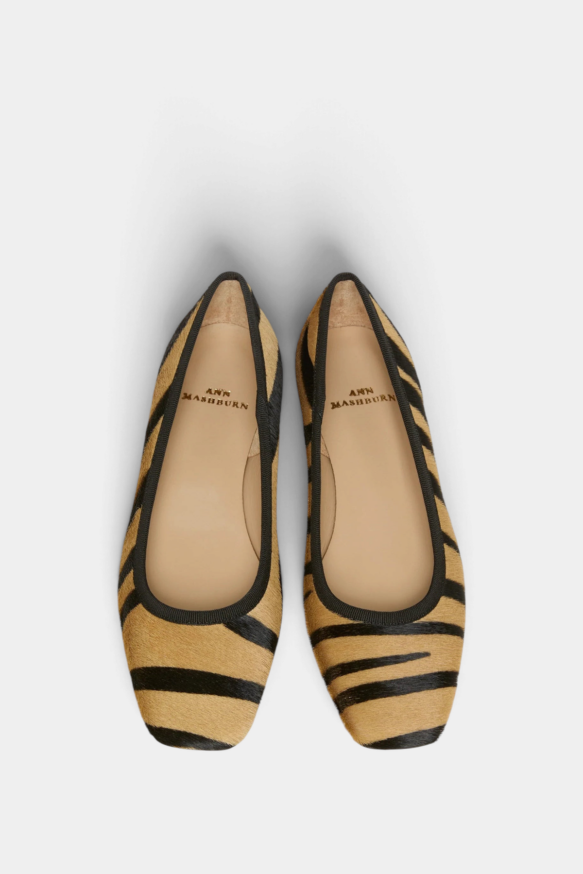 The Copper Shed Cecelia flat in zebra print calf hair with a cushioned insole and black trim, top-down view.