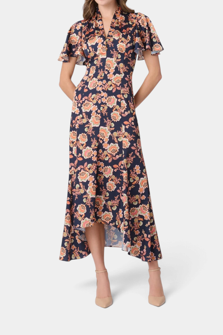 The Copper Shed Cinnie midi dress in navy floral satin with a draped V-neck, flutter sleeves, and asymmetric hem.