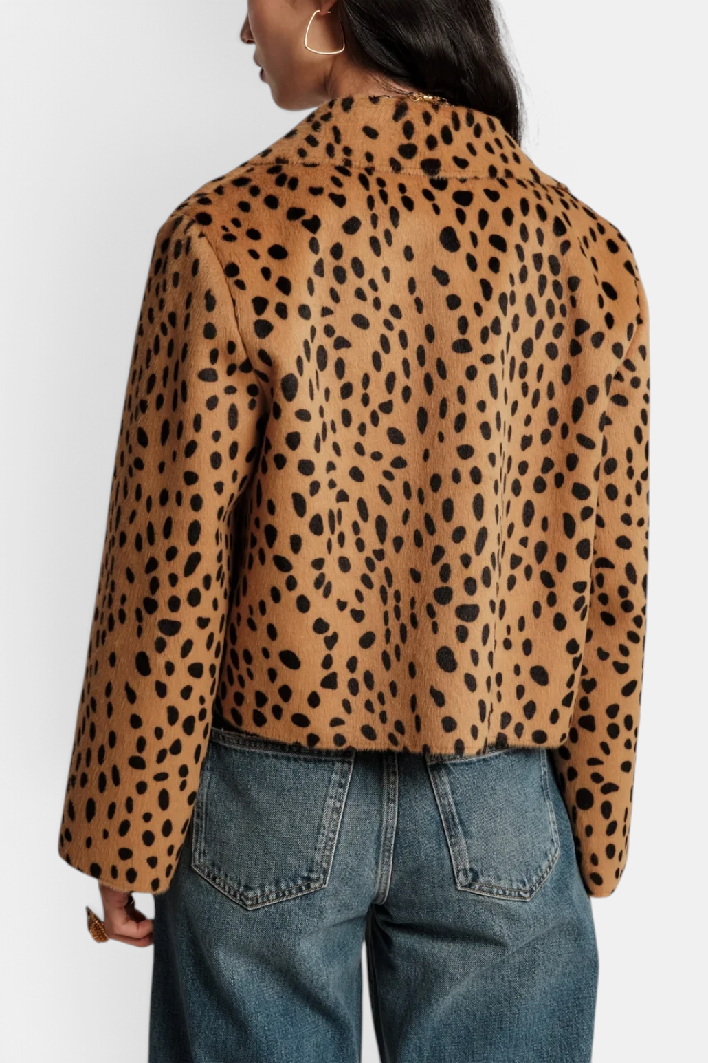 The Copper Shed Cosette cropped faux fur jacket in leopard print worn with blue jeans, back view