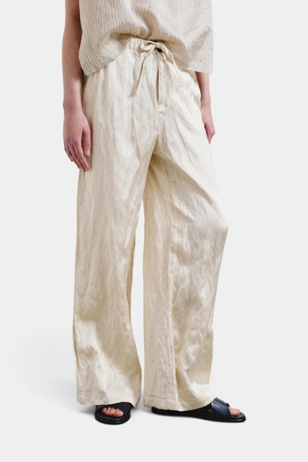 The Copper Shed crinkled viscose and metal satin wide-leg trousers in cream with an elastic drawstring waistband