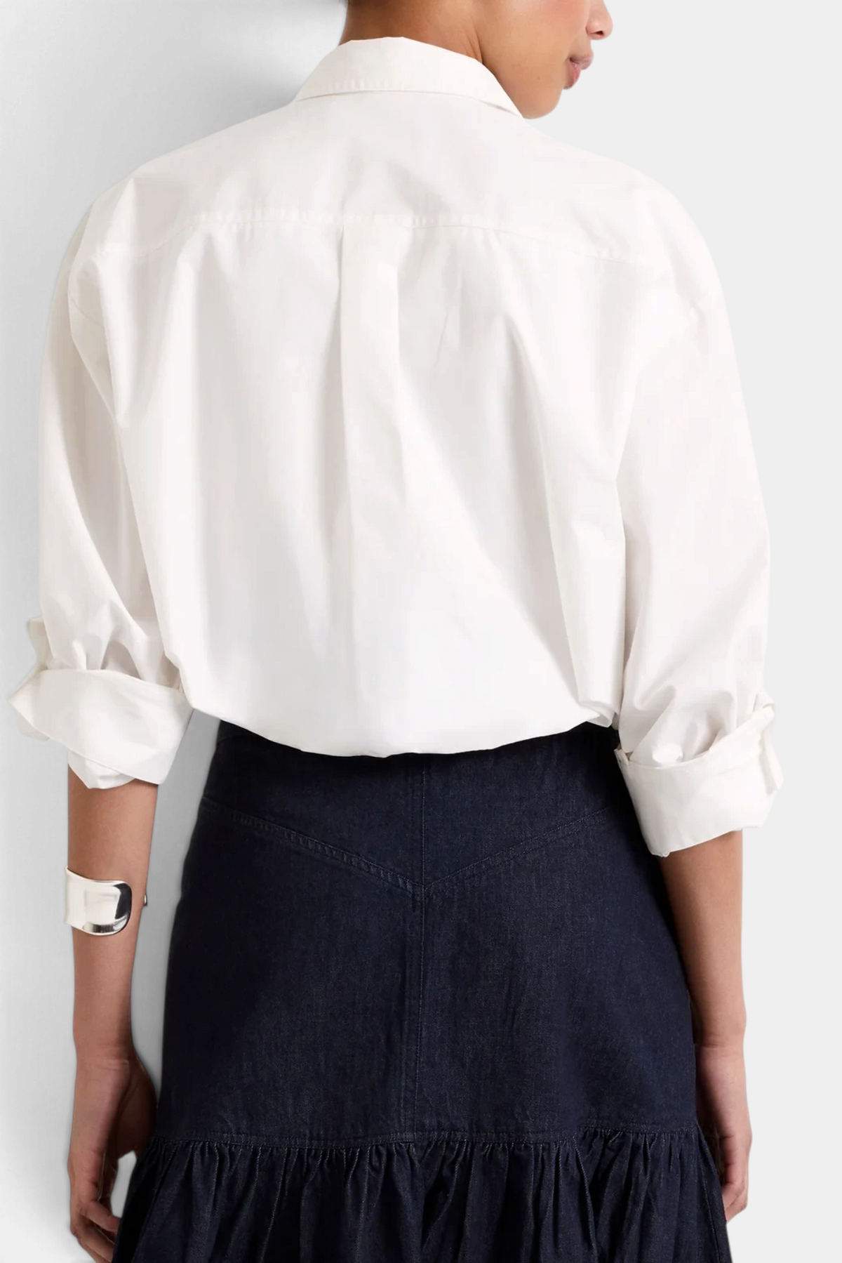 The Copper Shed Dallas Top in white cotton with a cropped bubble hem and adjustable sleeves, worn with a dark skirt.