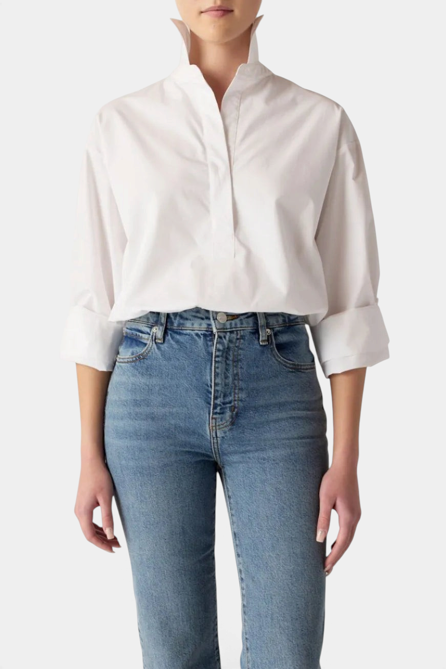 The Copper Shed Dallas Top in white cotton with a high collar, hidden button placket, and adjustable cuffed sleeves.