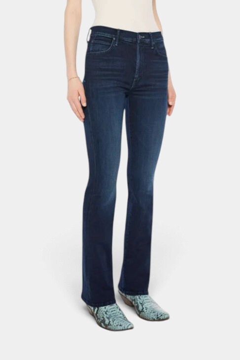 The Copper Shed mid-rise flared jeans in dark blue stretch denim with whiskering and a clean hem on a model