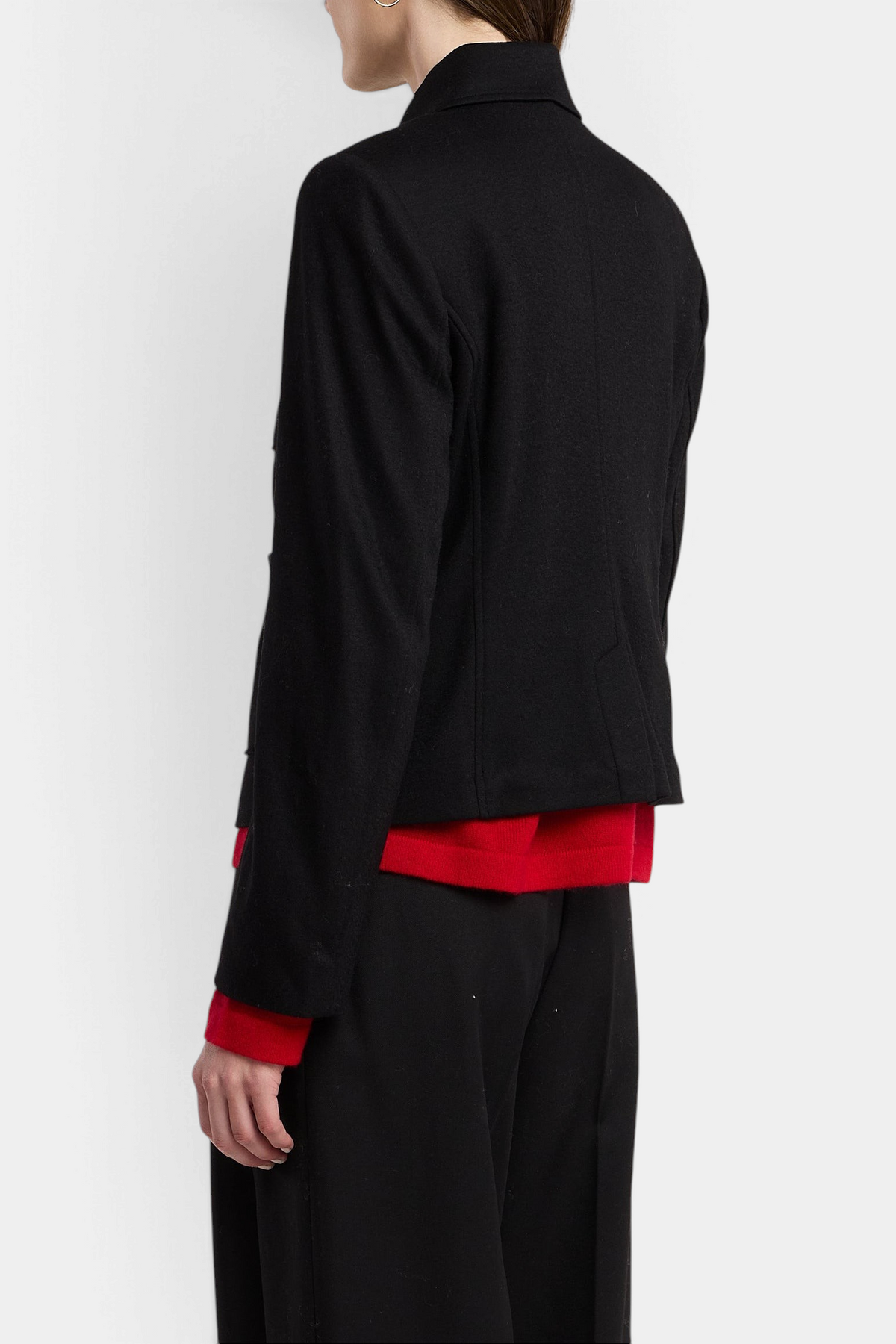 The Copper Shed Davina black wool-blend jacket worn over a red sweater and black trousers, side view