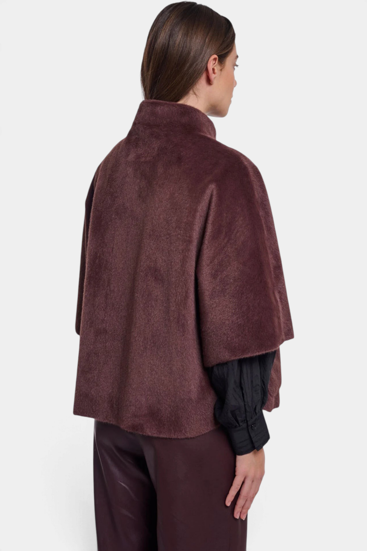 The Copper Shed Dewi cape in deep burgundy faux fur with a relaxed silhouette and short sleeves, back view.
