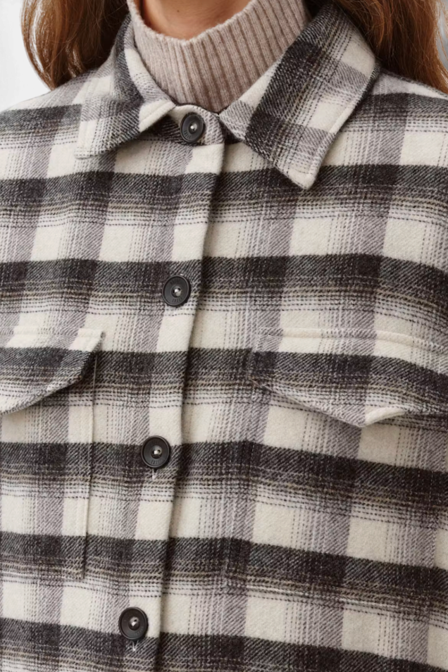 The Copper Shed Diega Sahra overshirt in a black and white wool-blend plaid pattern with button-down front pockets.