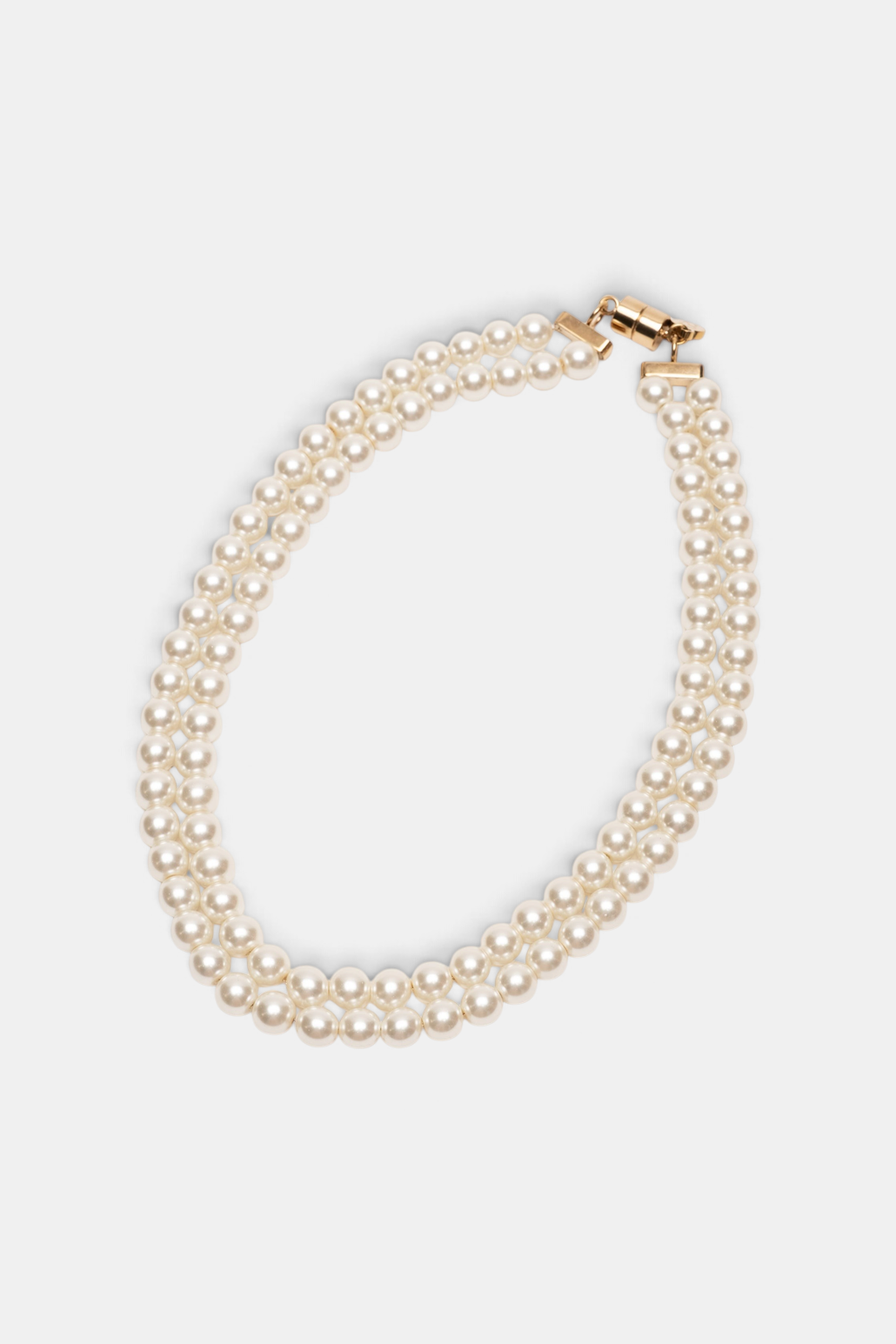 The Copper Shed double strand pearl necklace with gold plated magnetic closure on a light grey background