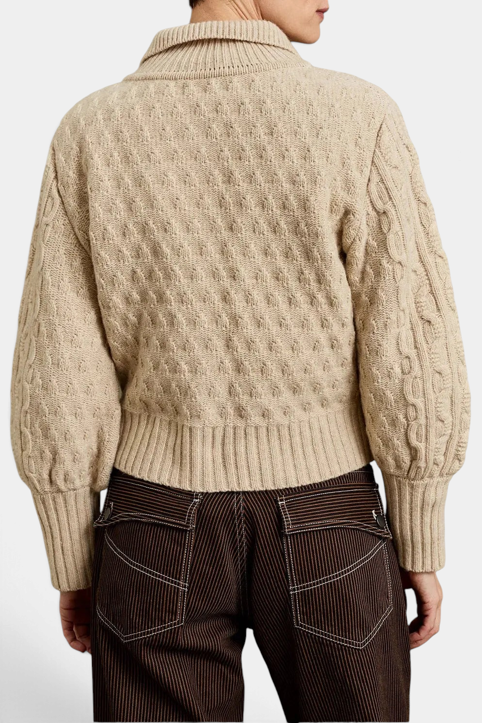 The Copper Shed Cornwall wool cardigan in ecru featuring a cable knit pattern and high collar, back view.