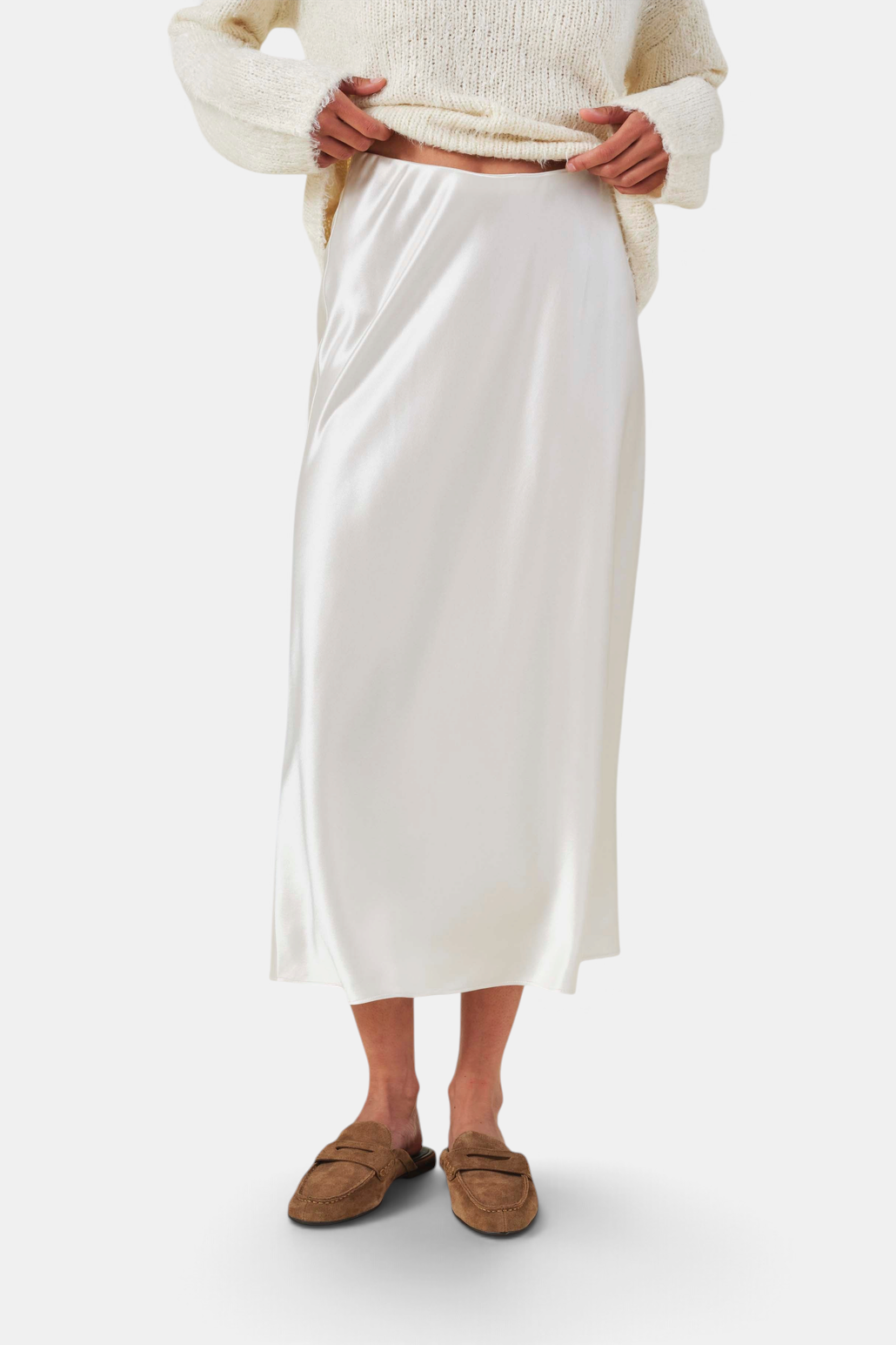 The Copper Shed Ella skirt in cream satin with a high-rise bias-cut silhouette and a smooth, elegant drape.