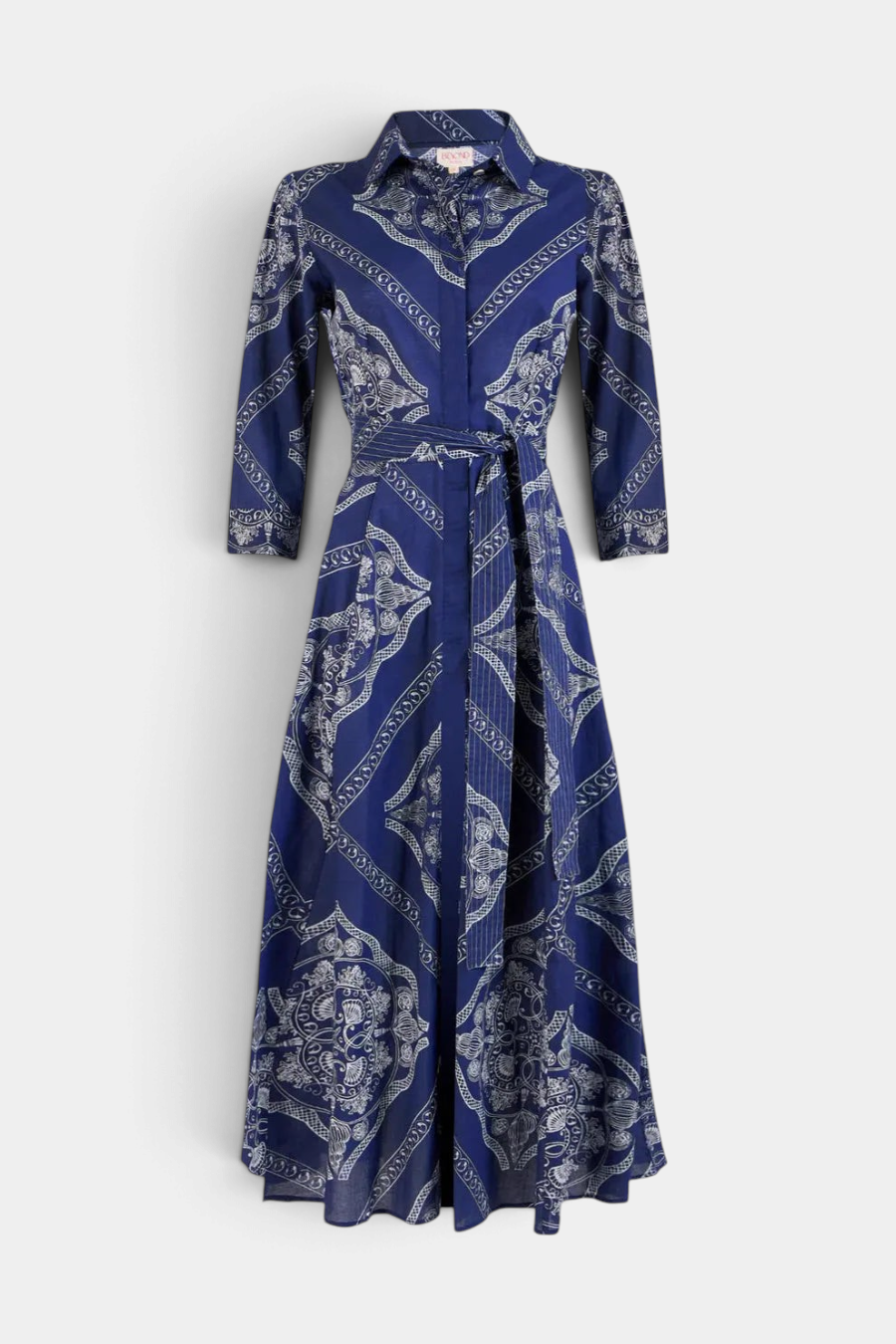 The Copper Shed Emily shirt dress in blue cotton voile with a white geometric print, 3/4 sleeves, and a waist belt.