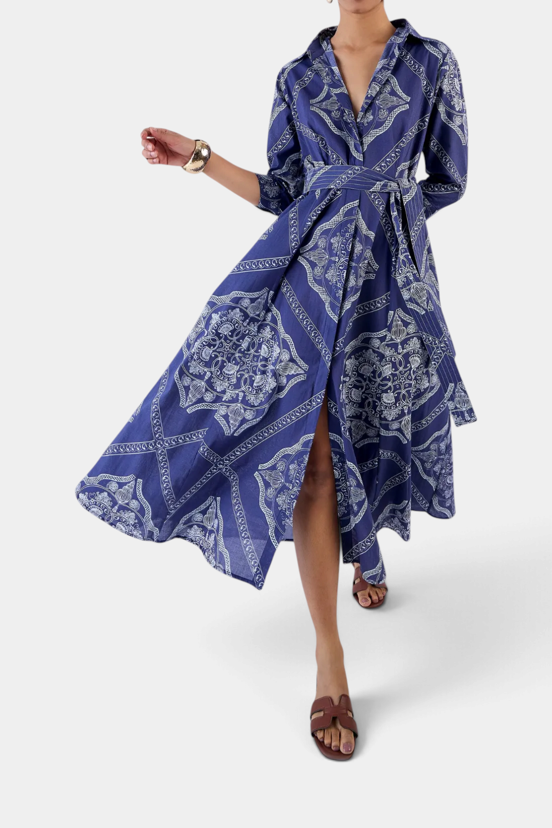 The Copper Shed Emily shirt dress in blue cotton voile with a white abstract print, 3/4 sleeves, and waist belt.