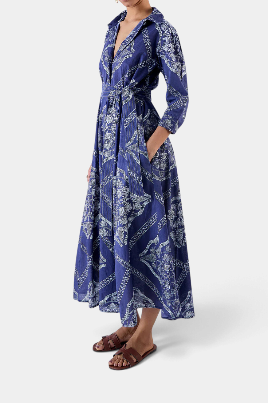 The Copper Shed Emily shirt dress in blue cotton voile with a white abstract print, 3/4 sleeves, and waist belt.