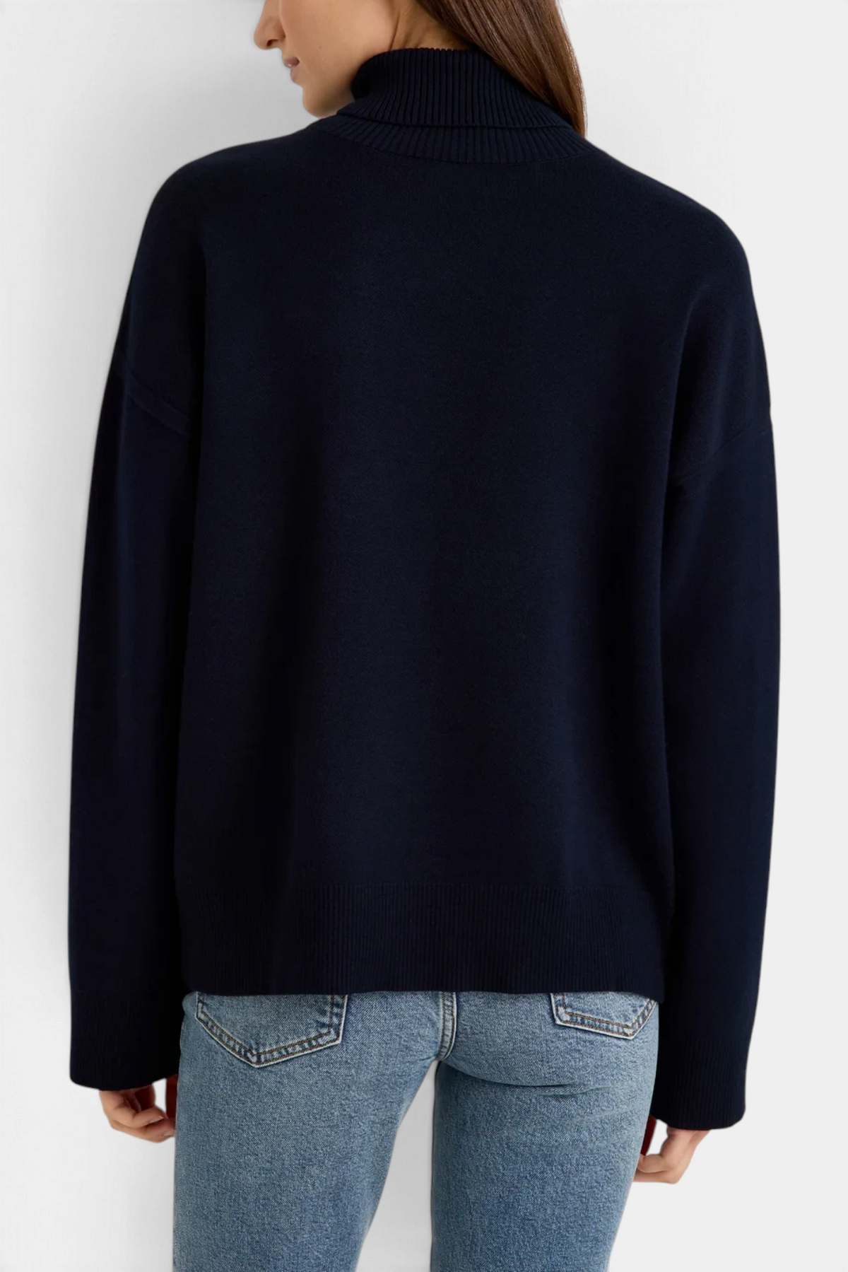 The Copper Shed Emmy sweater in deep navy featuring a mock neck and relaxed boxy fit, shown from the back.