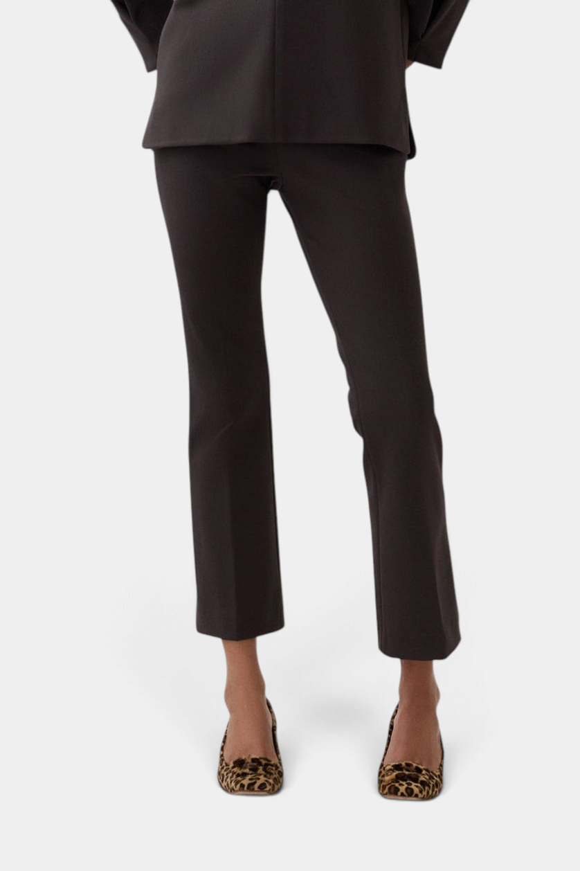 The Copper Shed Faye Flare Cropped Pant in black bi-stretch tricotine with an elastic waist and flared leg design.