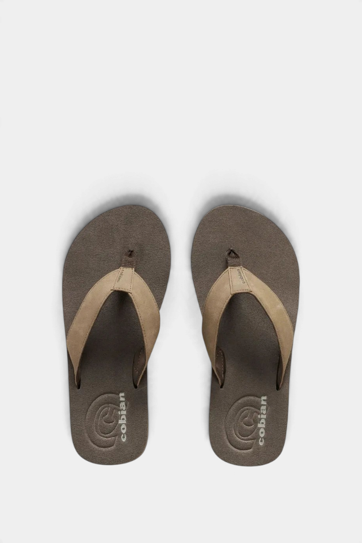 The Copper Shed Floater 2 beach flip flop with brown EVA footbed and tan padded synthetic strap with logo detail.