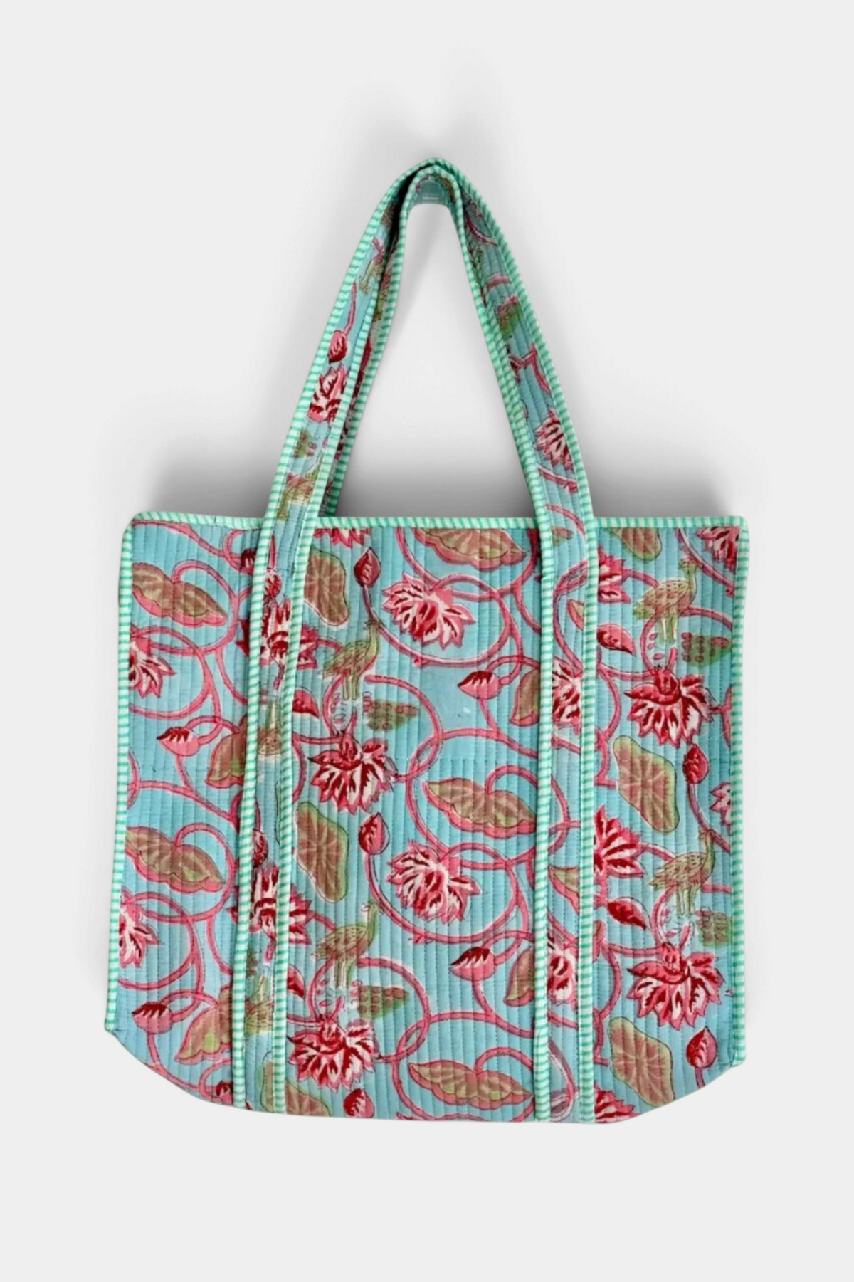 The Copper Shed reversible quilted cotton tote bag featuring a vibrant multicolor floral block print on light blue.