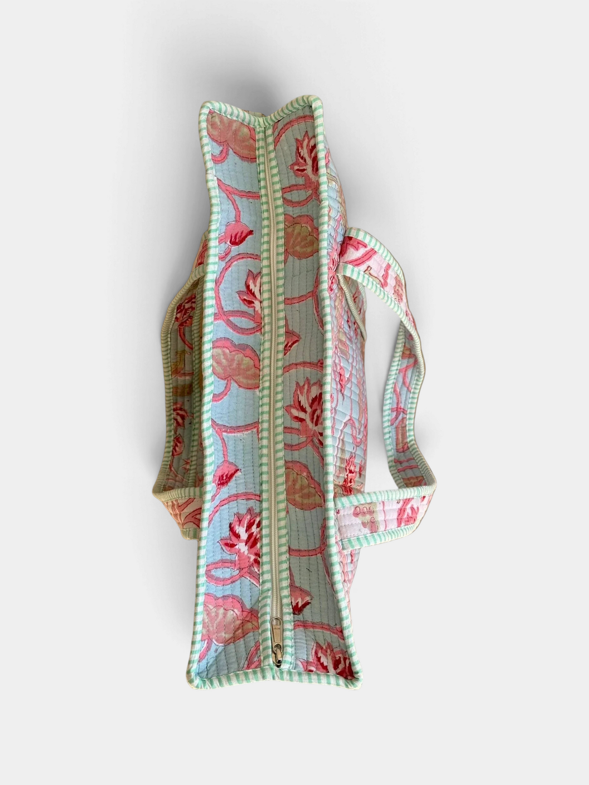 The Copper Shed reversible quilted cotton tote bag with multicolor floral block print and striped trim top view