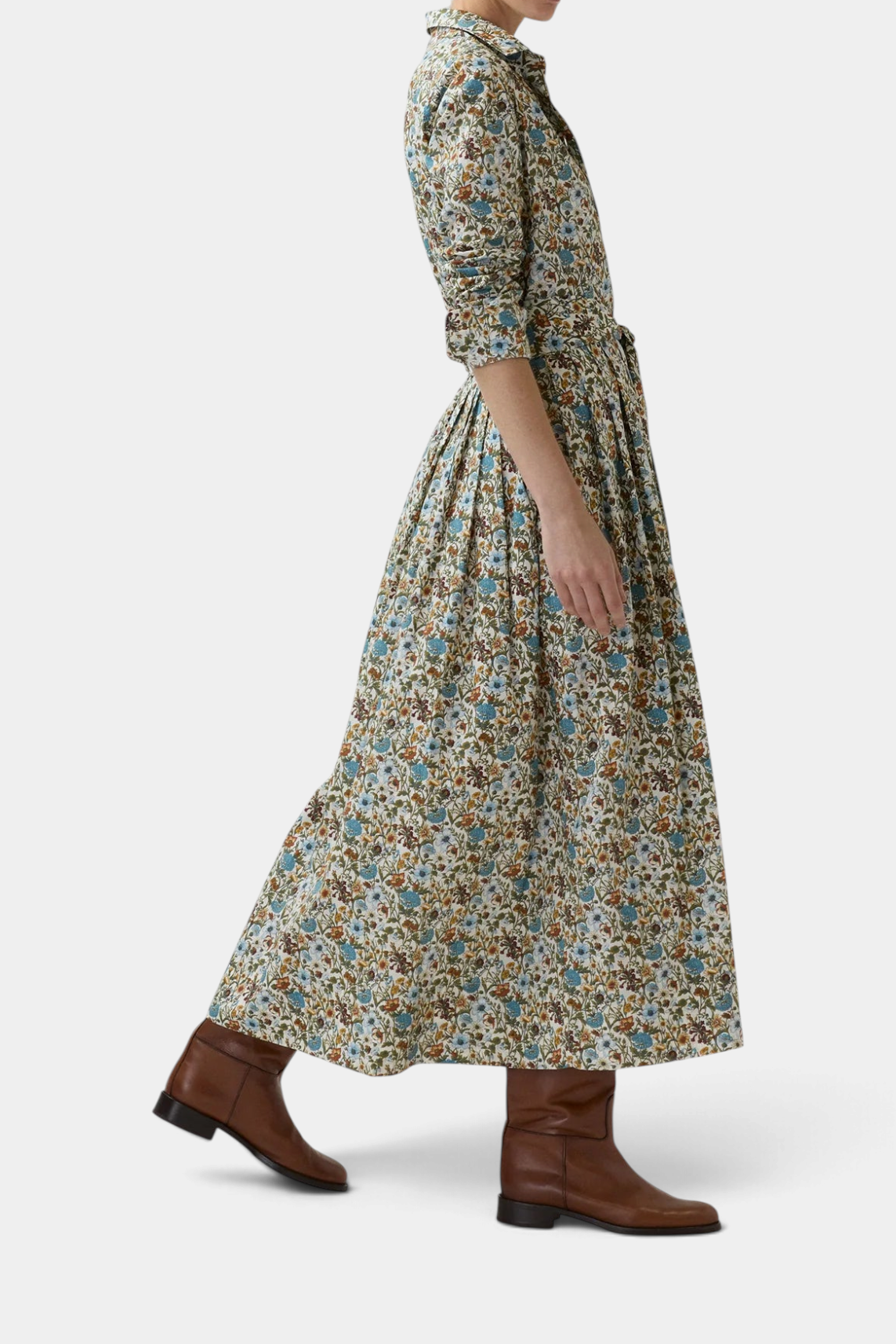 The Copper Shed floral Liberty Fabrics shirtwaist maxi dress with a pleated skirt and belt, worn with brown boots.
