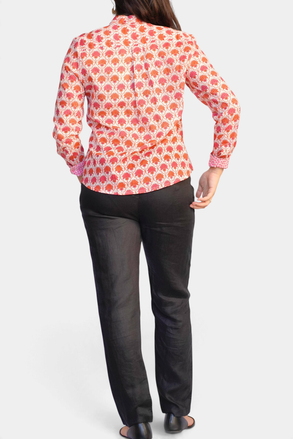 Back view of The Copper Shed Frannie long sleeve cotton shirt with orange floral block print and pink cuffs