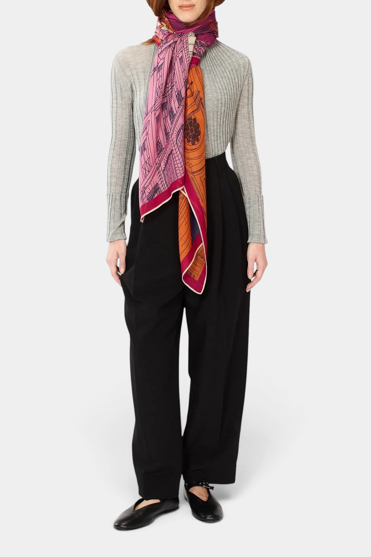 The Copper Shed fuchsia Paris print scarf in washable wool worn by a model in a grey ribbed top and black trousers