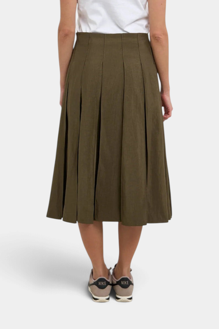 The Copper Shed Gemma midi pleated skirt in sandwashed olive rayon cotton blend, back view on a model.