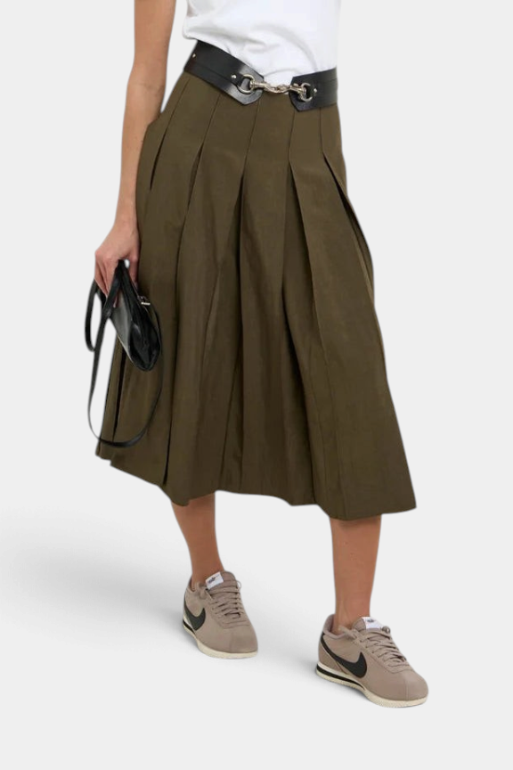The Copper Shed Gemma midi pleated skirt in sandwashed olive green rayon-cotton blend with a side zip closure.