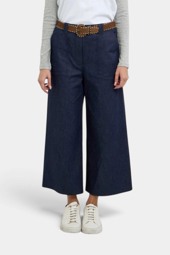 The Copper Shed Gerri Pant in dark denim with contrast luggage-colored topstitching, front pockets, and belt loops.